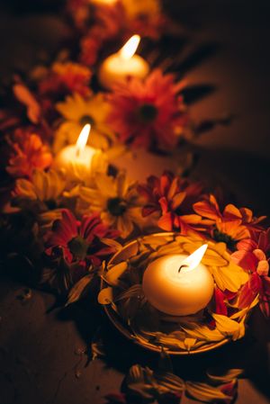 Lit candles surrounded with flowers