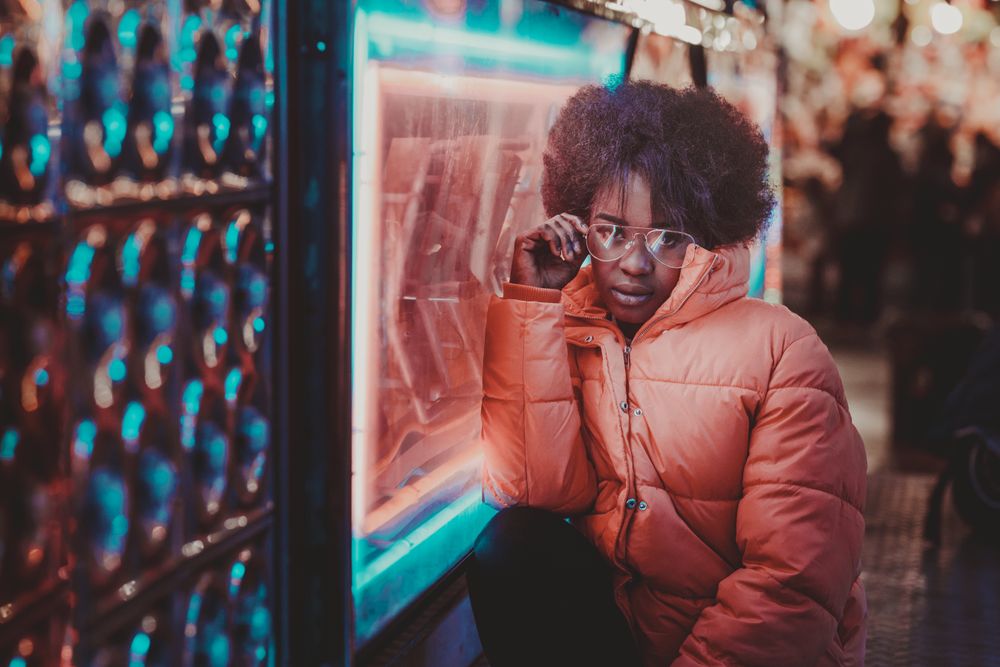 Black woman standing on night city street