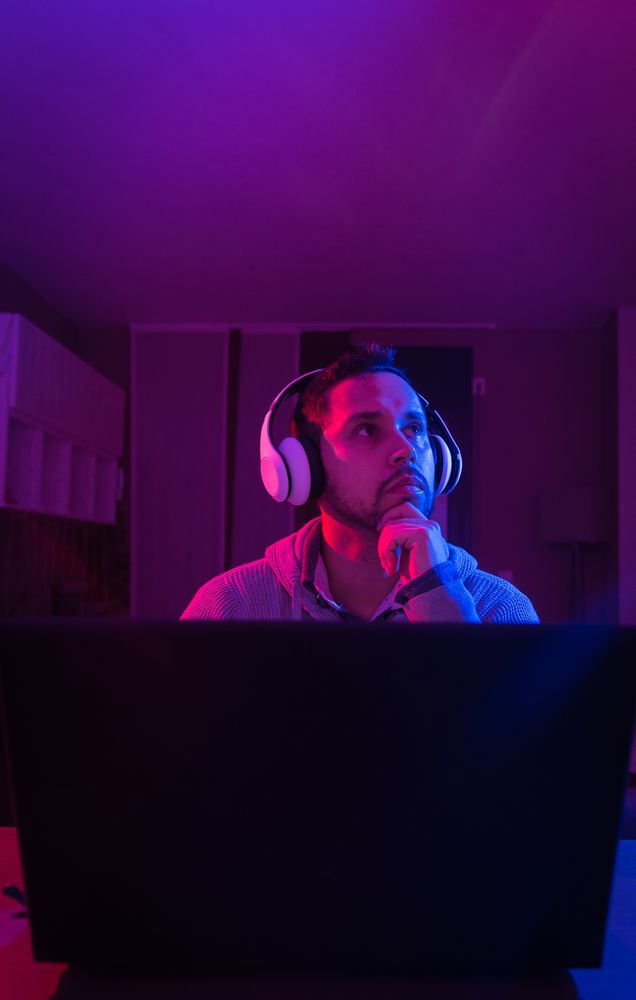 Man listening cheerfully to music with headphones.