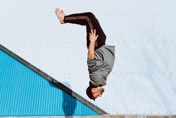 Trendy male flipping on street