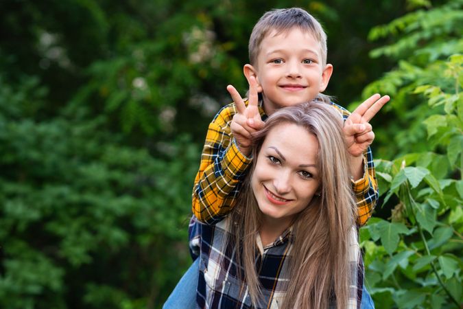 Portrait of mother playing with son in backyard