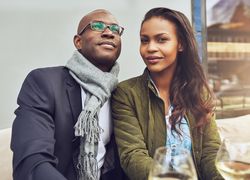 Black couple dining al fresco with wine