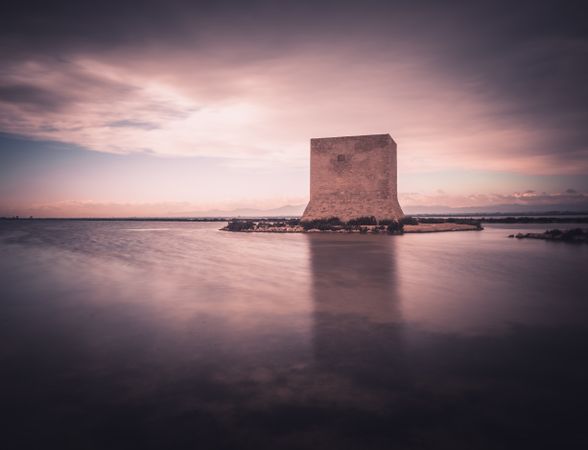 Wonderful watchtower in calm lake on cloudy day