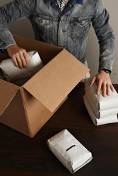 Man packaging and preparing coffee beans for shipment