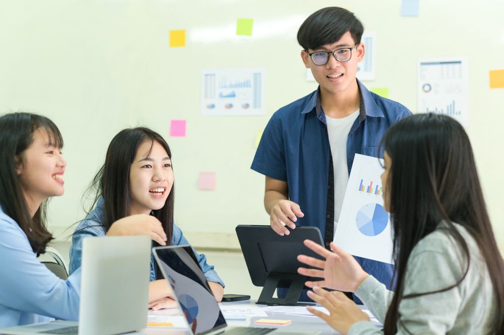 Group of young people brainstorming for work.