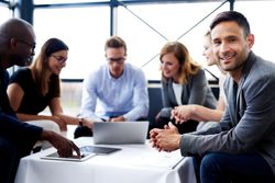 Businessman with his colleagues having an informal meeting in an office