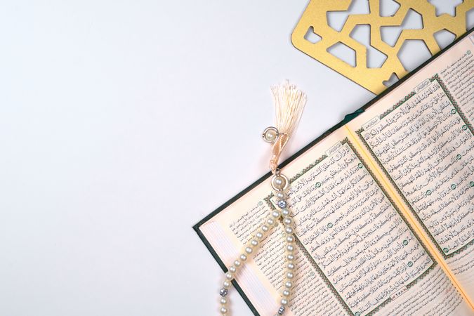 Open Quran With Prayer Beads and Intricate Decorative Element