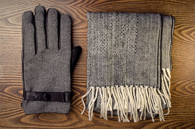 Gloves and scarf on wooden table