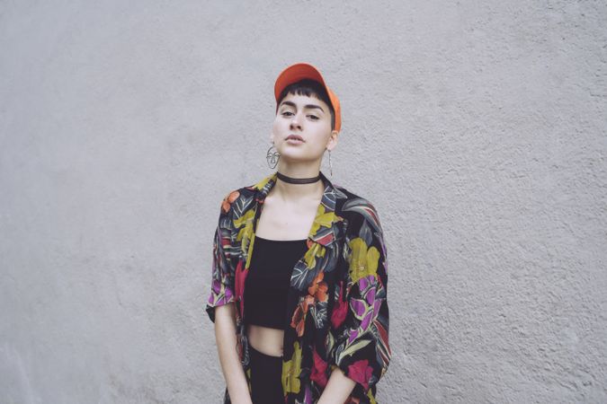 Woman in orange cap looking at camera sideways