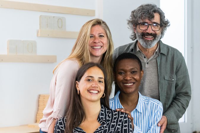 Cheerful diverse coworking women looking at camera