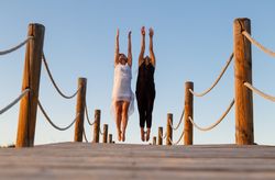 Women posing in air on footbridge