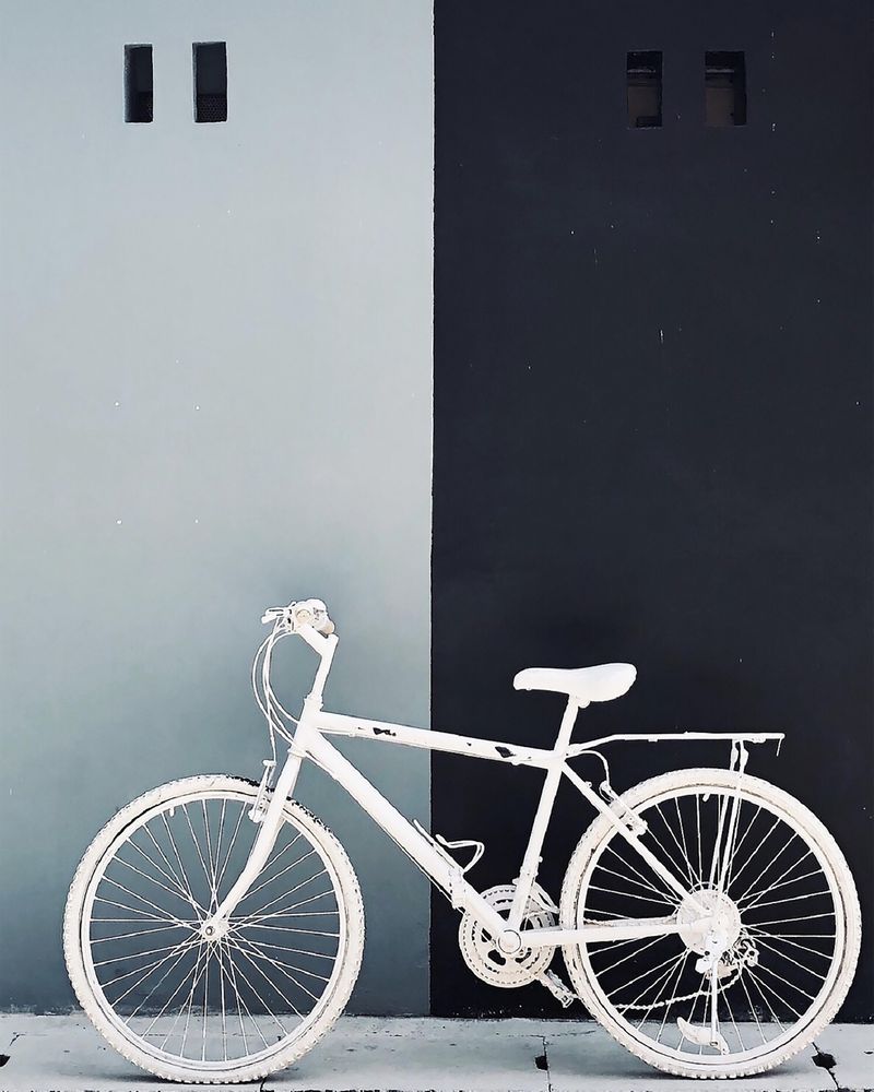 Light bike leaning on dark wall