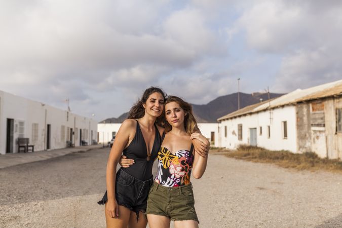 Women hugging on old town street
