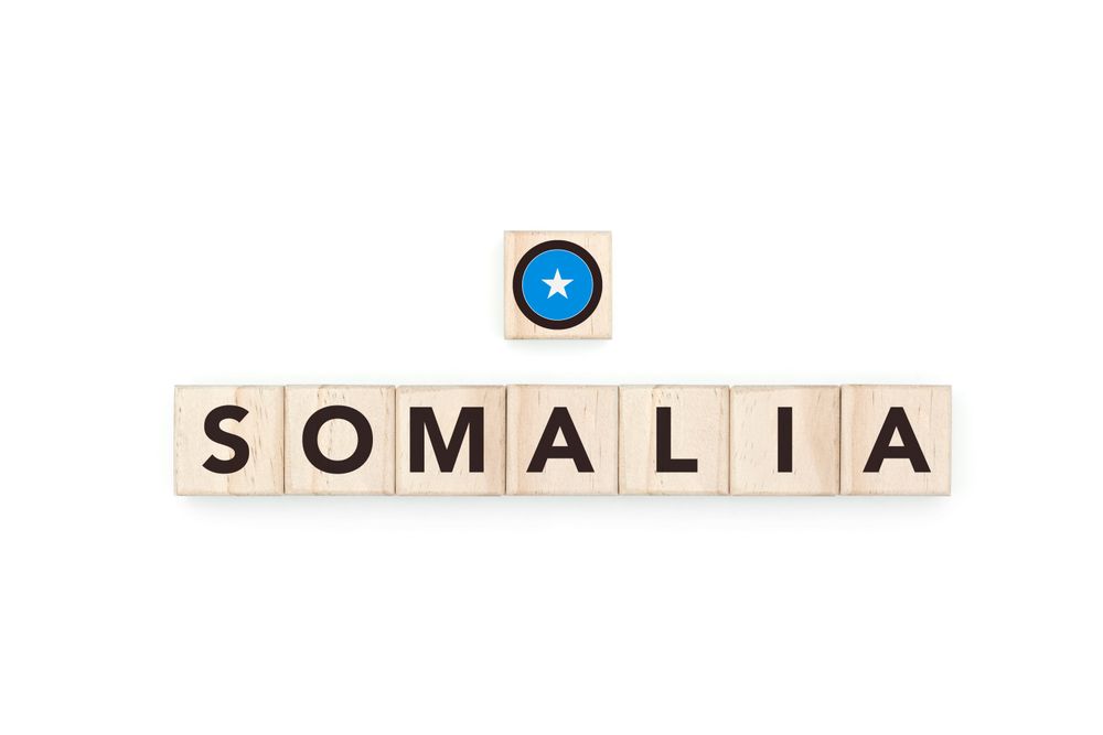 Wooden blocks bearing the name and flag of Somalia. Somali and African Culture, national identity, travel, and geography in a copy space design.
