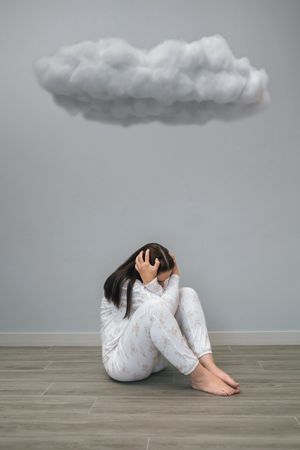 Unrecognizable woman  under a dark cloud