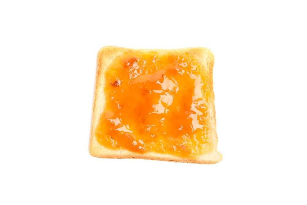 Toast with apricot jam isolated on plain background