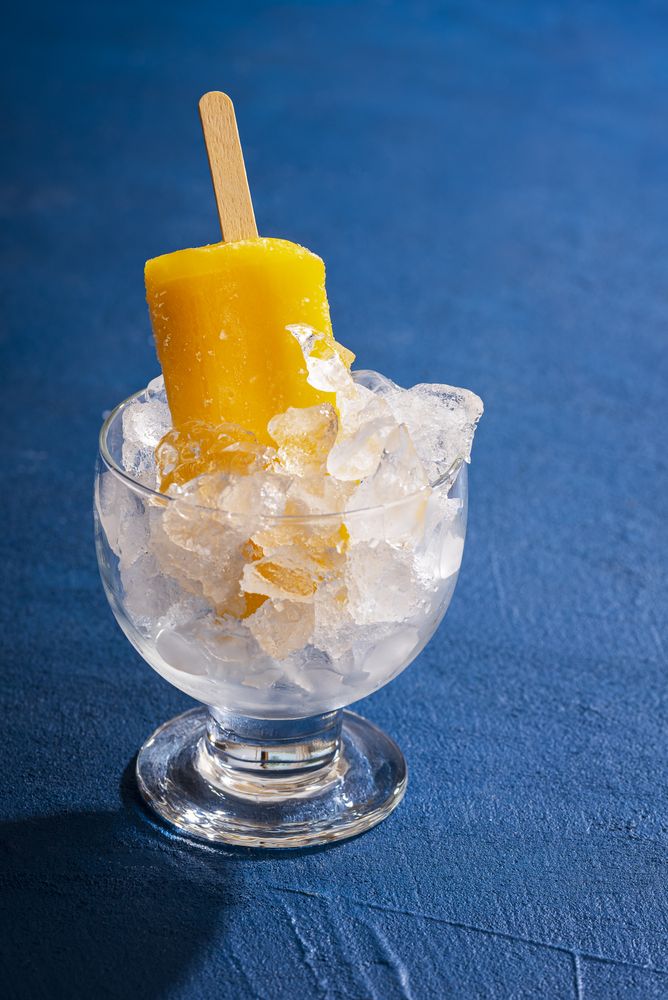 Orange popsicle ice cream cooling in crushed ice
