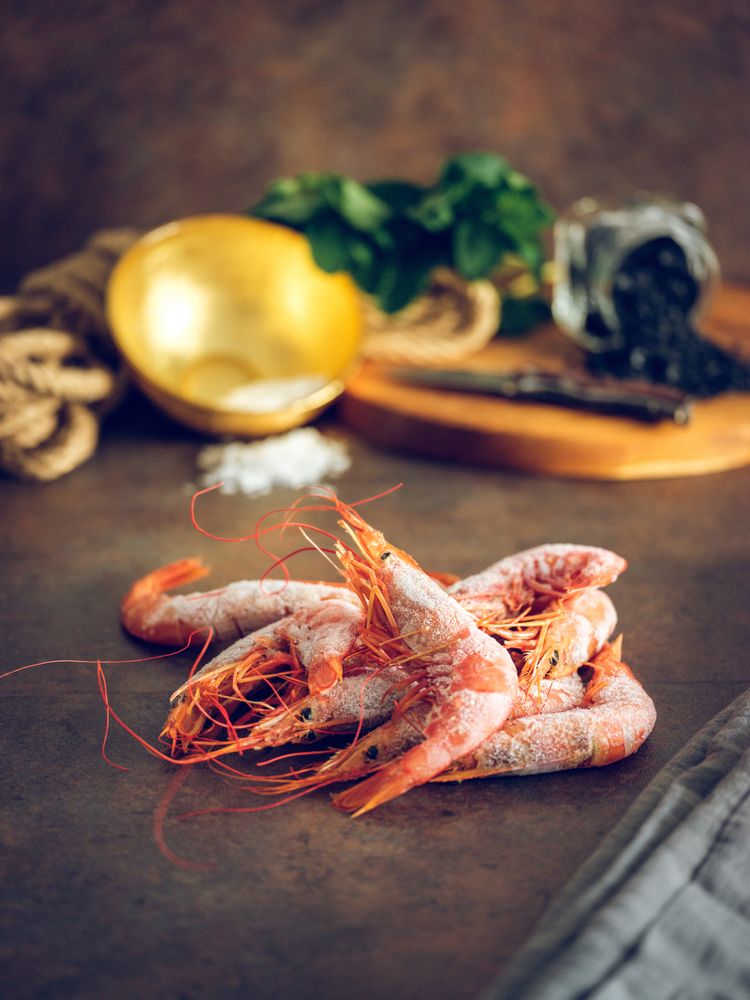 Raw prawns on table in domestic kitchen