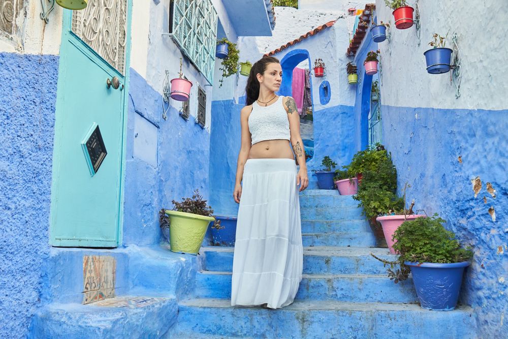 Woman on steps between ancient buildings