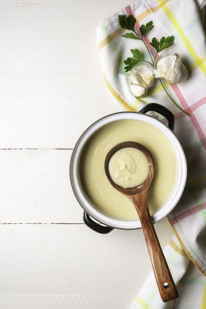 Cream soup in a pot top view