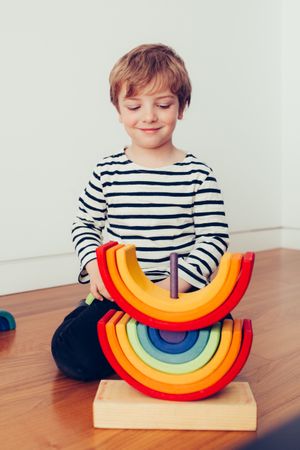 Boy playing with wooden construction pieces