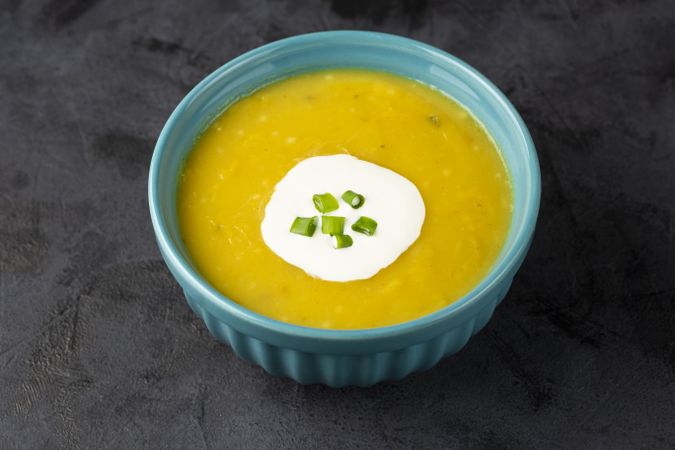 Bowl with pumpkin soup on the table.