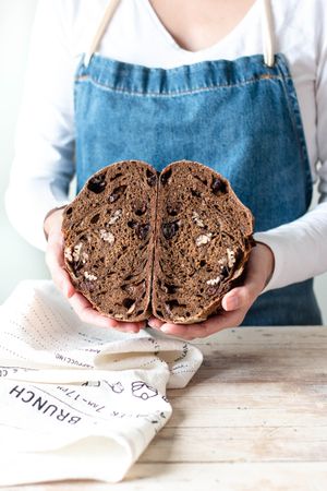 Hands of woman holding rye bread