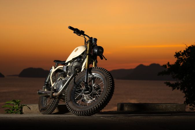 Motorbike near sea during sunset