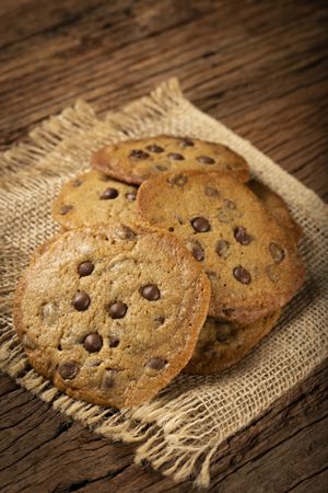 Delicious chocolate cookies on wooden table.