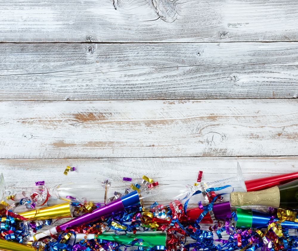 Happy New Year Celebration with party objects and champagne on rustic wooden boards