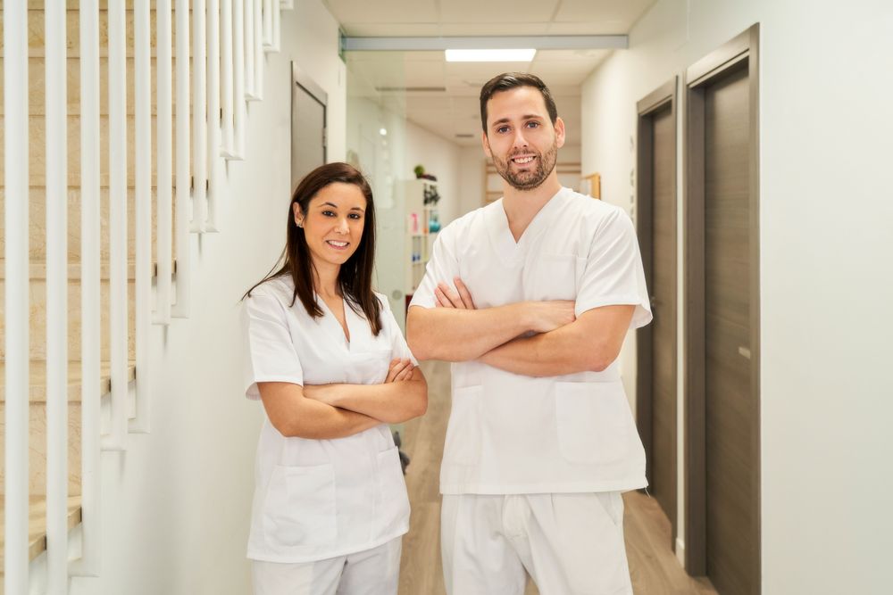 portrait of two physiotherapists in their clinic looking at the