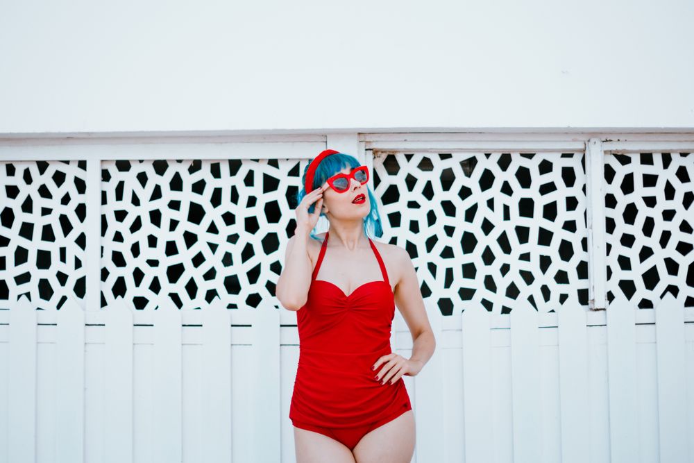 Stylish woman in red swimwear with hand on waist