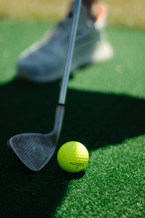 Golf ball on green grass field in close-up