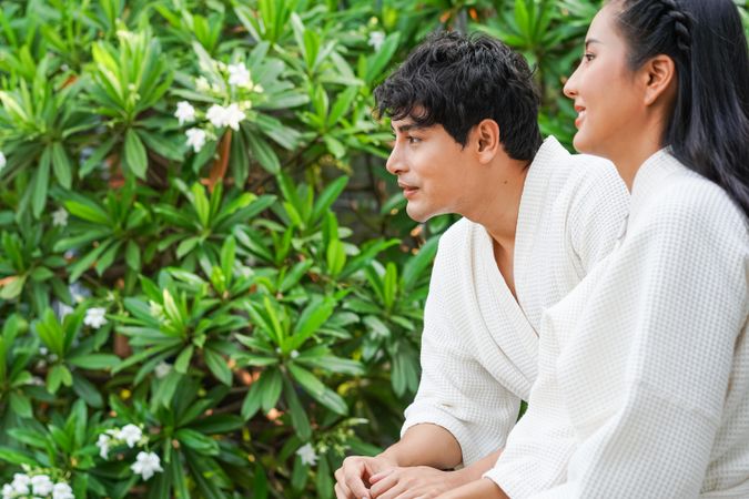 Asian couple outside in hotel bathrobe