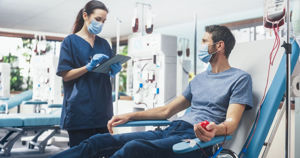Man Donating Blood For People In Need In Bright Hospital.