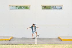 Active preteen skateboarder in VR glasses on street