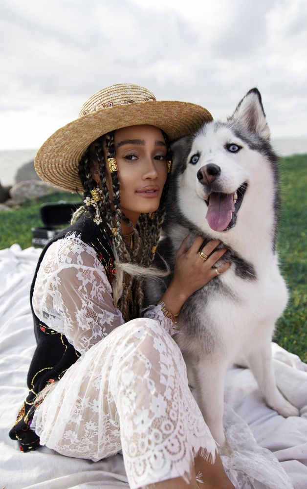 Woman sitting beside husky outdoor