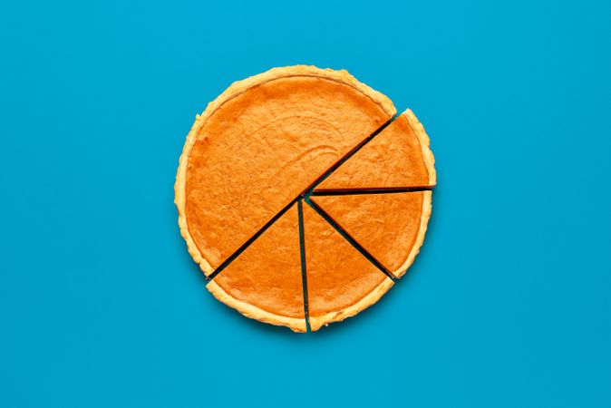 Homemade pumpkin tart on a blue background