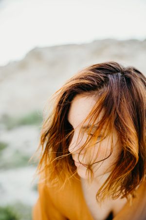 Dreamy attractive young woman posing outdoors
