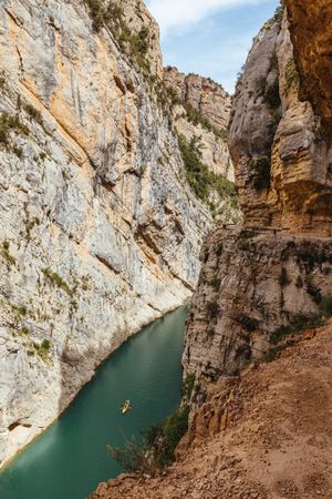 People crossing a river by kayak