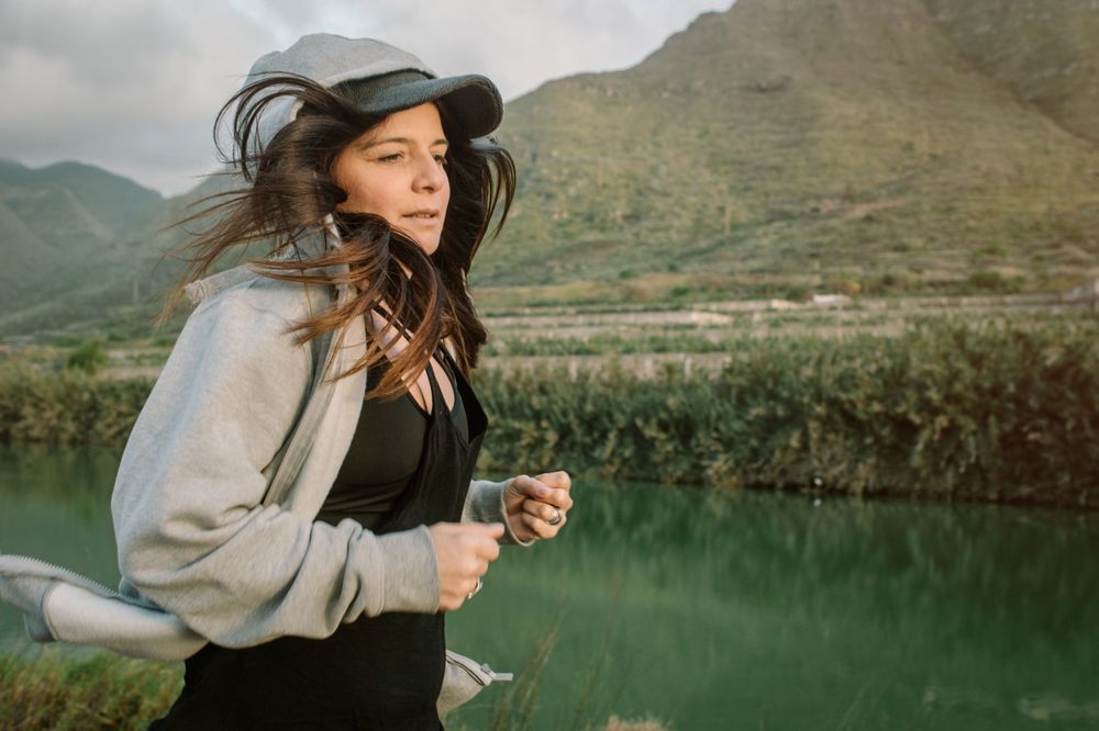 Positive woman running in park