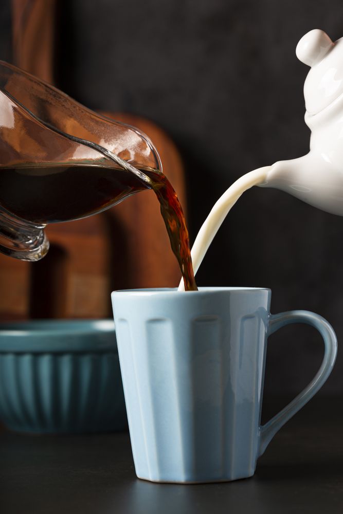 Cup of coffee with creamy milk.