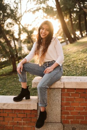 Cheerful young woman in park