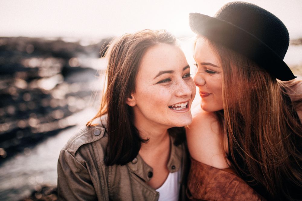 Two young women smiling and having fun outside