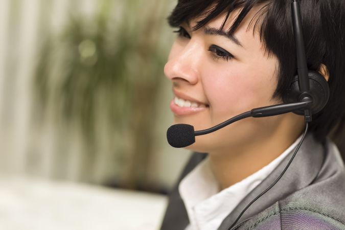 Young Woman Smiles Wearing Headset