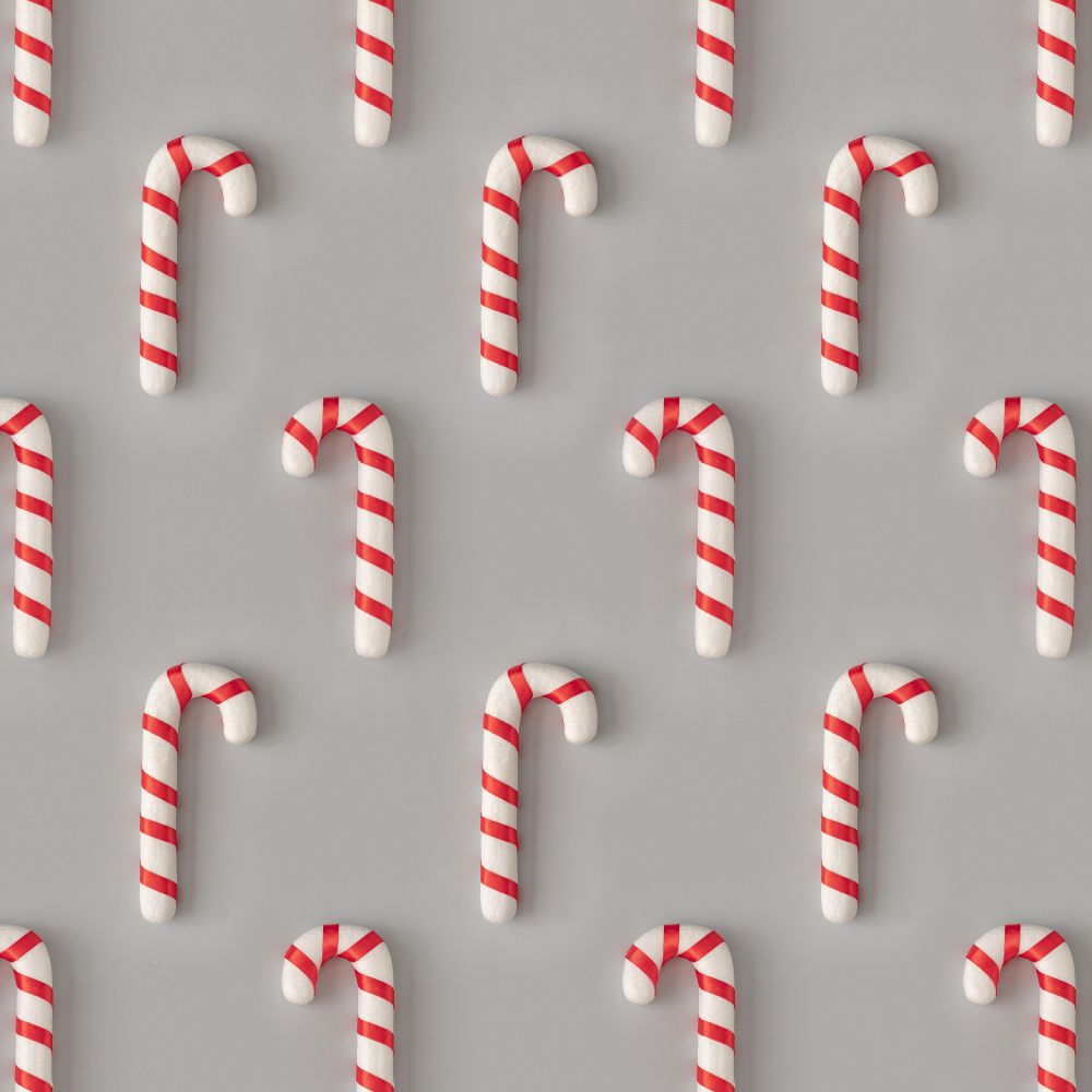 Holiday pattern with candy canes on gray background