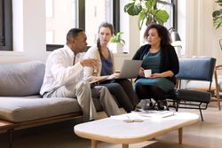 Man and two women having a business meeting