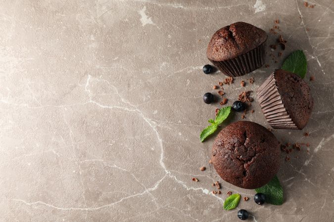 Composition with chocolate muffins on gray background