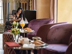 Positive female eating breakfast in luxury restaurant