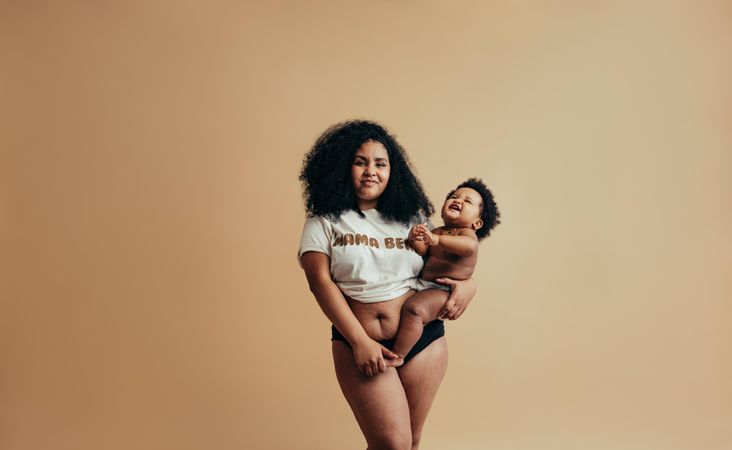 Curvy woman wearing mama bear t-shirt while holding her adorable baby